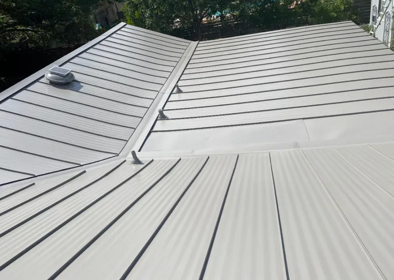 Solar attic fan installed on a metal roof for Roof Ventilation in Rochester
